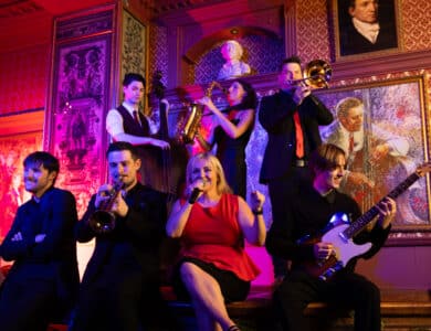Lively jazz band performing in elegant hotel lounge, with vintage décor and vibrant lighting, creating a warm, welcoming atmosphere.