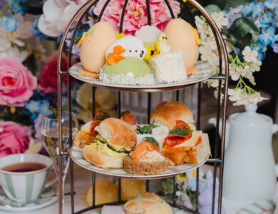 Enjoy elegant afternoon tea with pastries and sandwiches amidst vibrant flowers at our luxury hotel. Perfect for relaxing getaways.