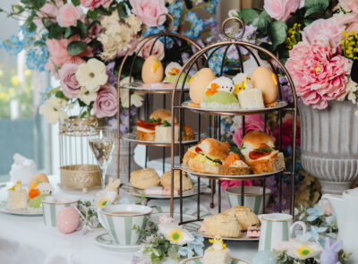 Indulge in afternoon tea with elegant tiered trays, floral decor, and delectable treats at our hotel's serene lounge.